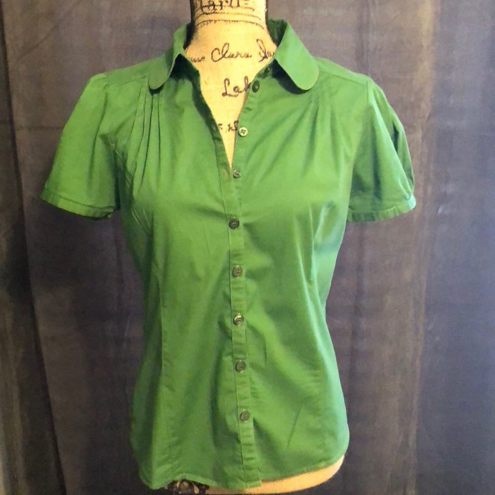 Dark green tailored top.